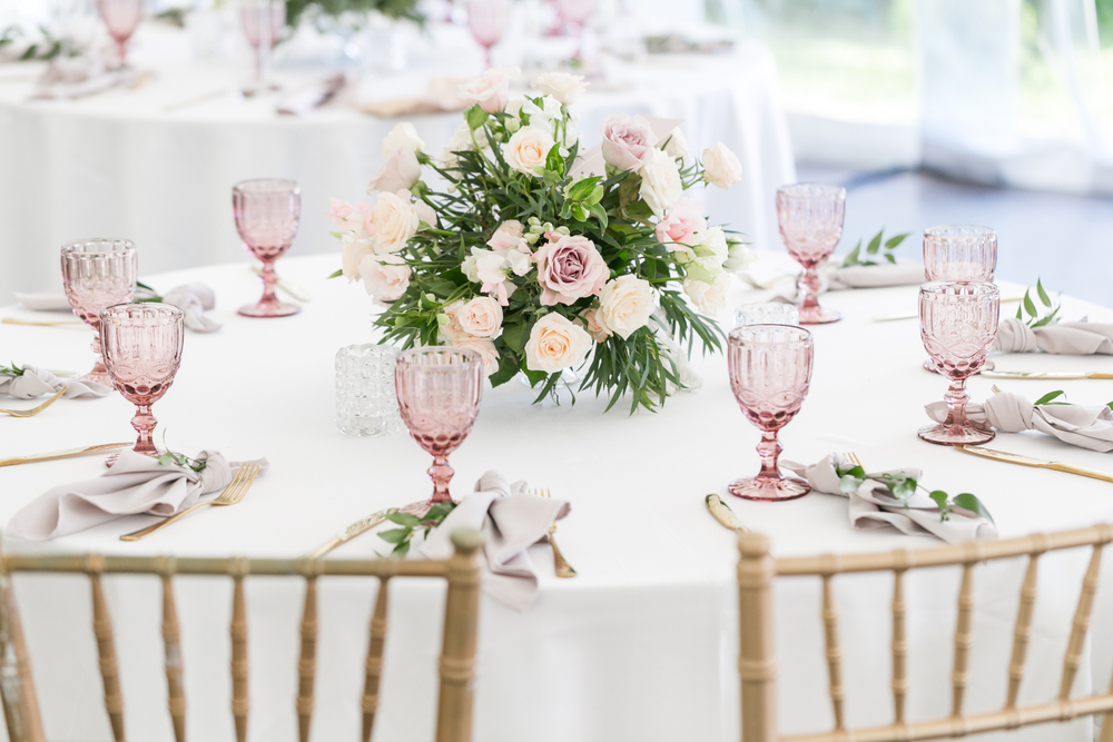 A wedding table set with various coloured glassware